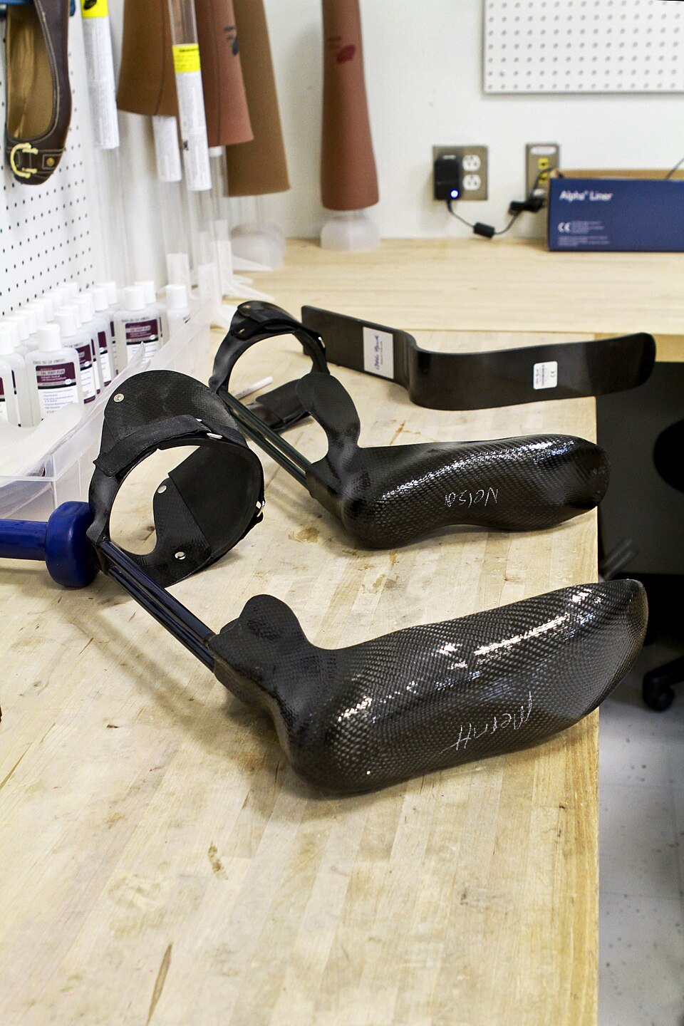 Several leg braces of different sizes lined up on a bench