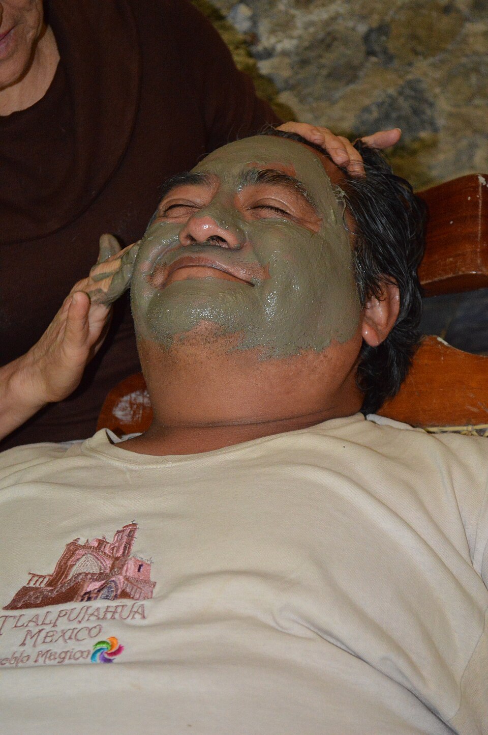 A woman resting with a cosmetic mask covering her face